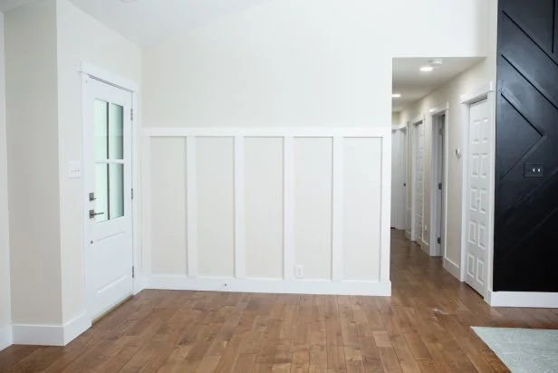 The next step in installing this DIY accent wall is to finish installing the trim pieces and caulk the joints.